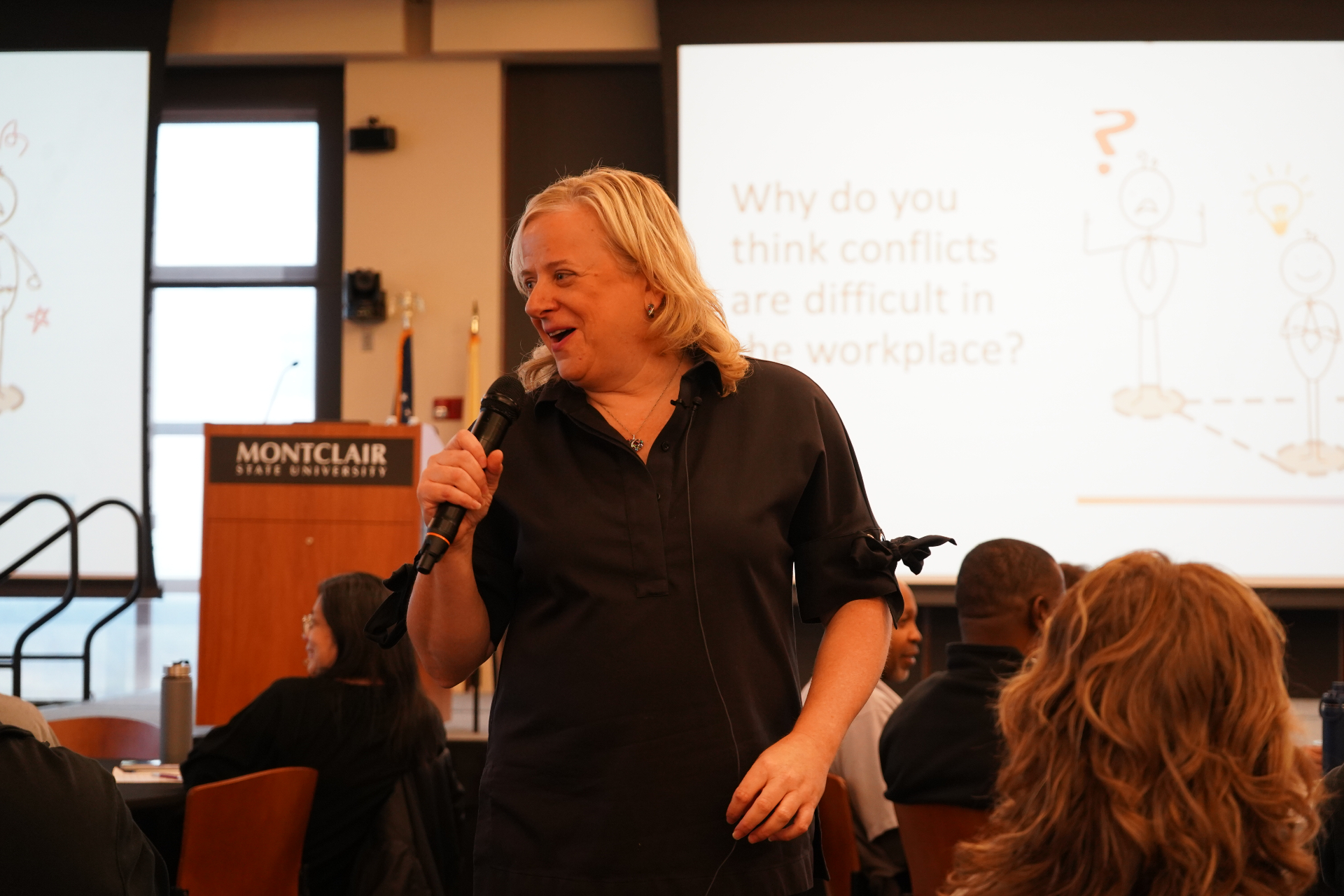 Julie Riga speaking on stage — Stay On Course Studios