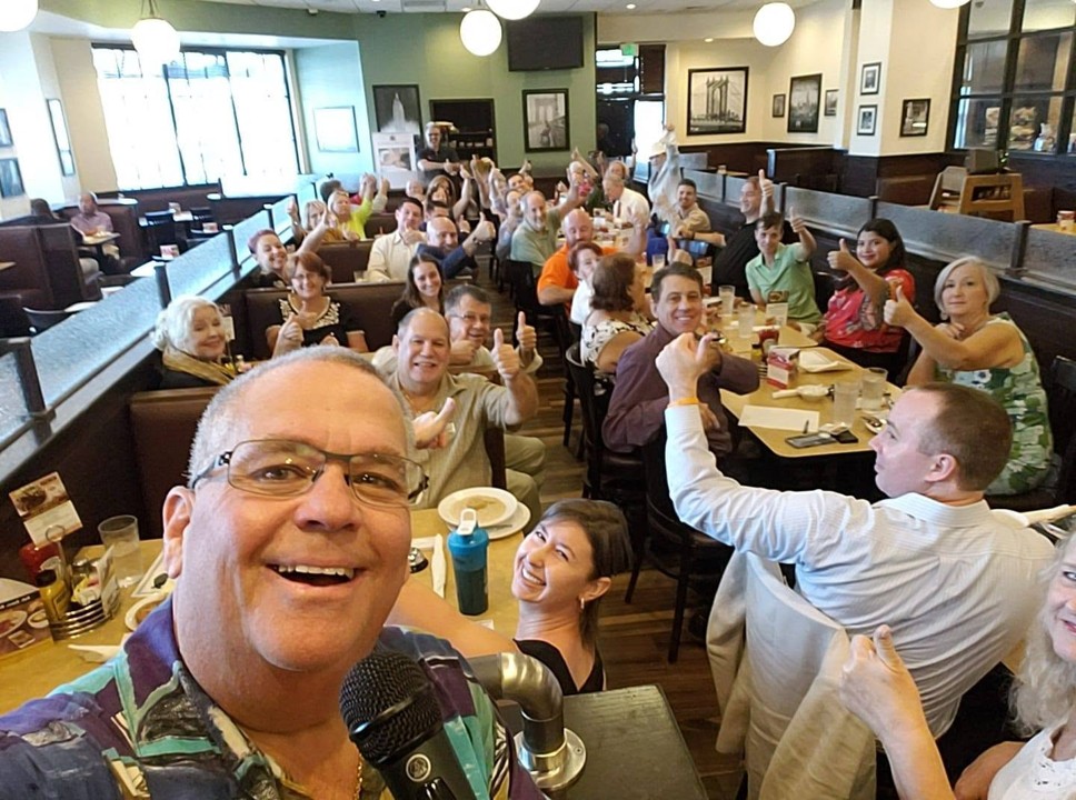 EPIC! members at a lunch mixer giving thumbs up